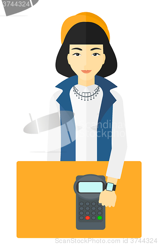 Image of Woman paying with smart watch.
