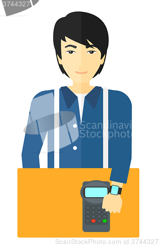 Image of Man paying with smart watch.