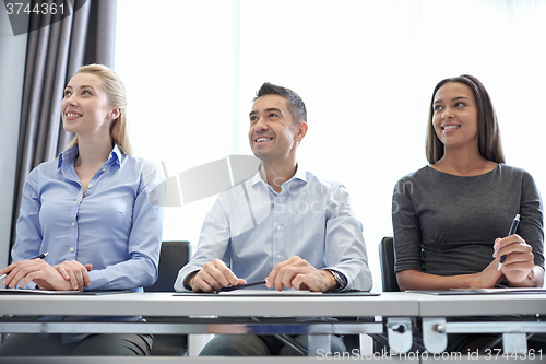 Image of smiling business people meeting in office