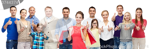 Image of happy people with shopping bags showing thumbs up