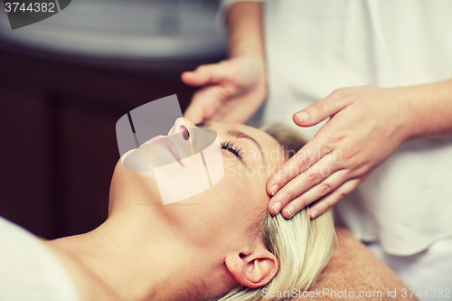 Image of close up of woman having face massage in spa