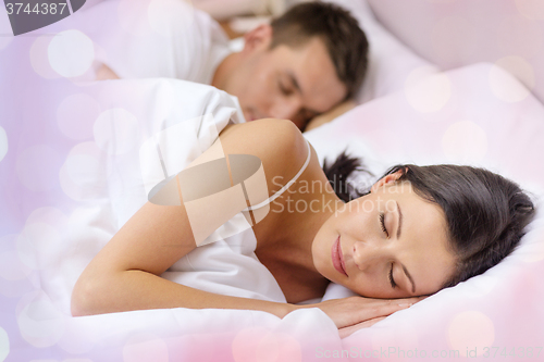 Image of happy couple sleeping in bed