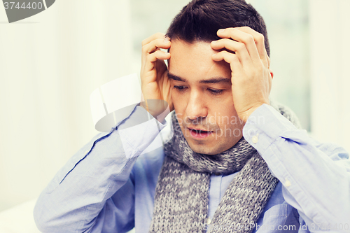 Image of close up of ill man with flu and headache at home