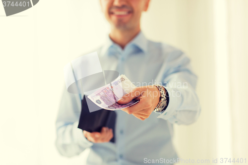 Image of close up of businessman hands holding money