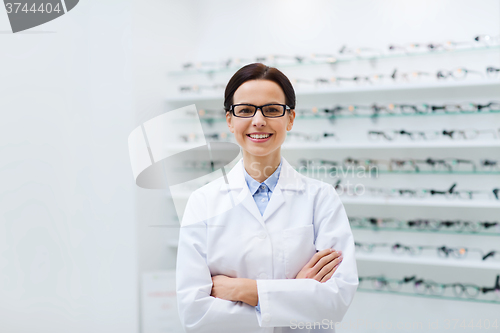 Image of woman optician in glasses and coat at optics store