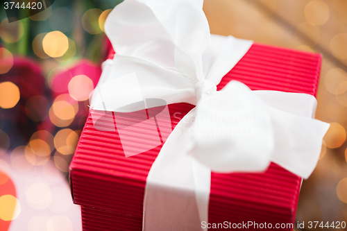 Image of close up of red gift box with white bow