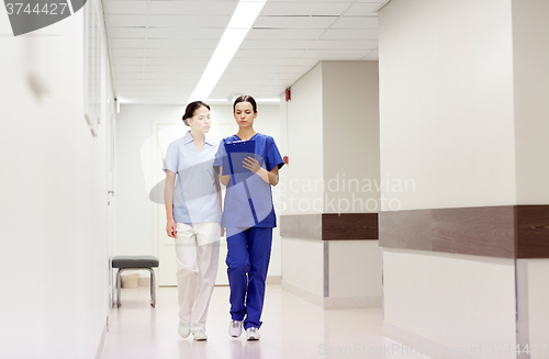 Image of two medics or nurses at hospital with clipboard
