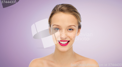 Image of smiling young woman face and shoulders