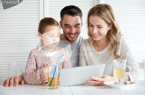 Image of happy family with tablet pc at restaurant