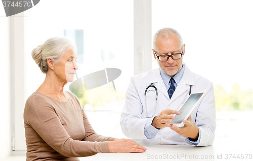 Image of senior woman and doctor with tablet pc