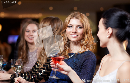 Image of happy women with drinks at night club