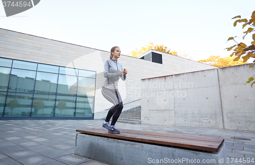 Image of woman exercising on bench outdoors