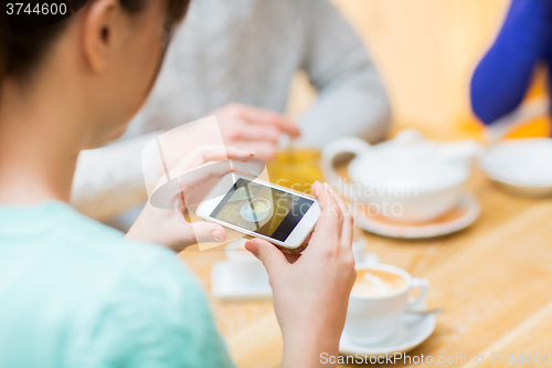 Image of close up of woman smartphone picturing coffee cup