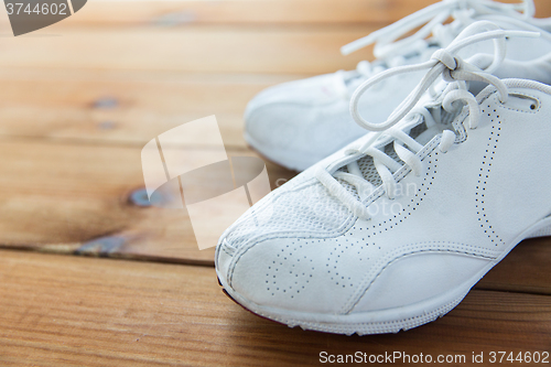 Image of close up of sneakers on wooden floor