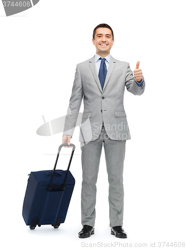 Image of happy businessman in suit with travel bag