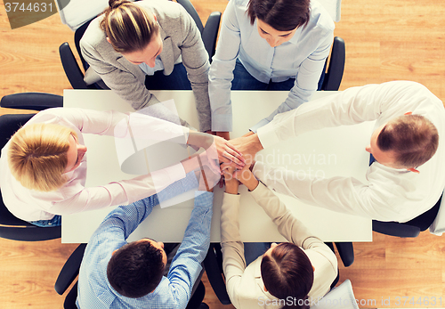 Image of close up of business team with hands on top