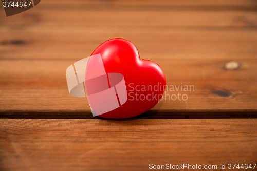 Image of close up of red heart decoration on wood