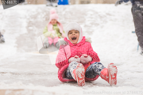 Image of Joyful child rolls a seven-year ice slides