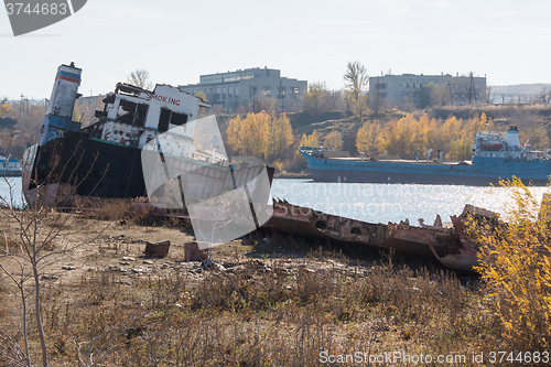 Image of Partially dismantled boat on the river