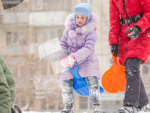 Image of Five-year girl on top of an icy hill preparing to move out down