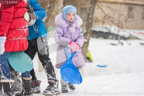 Image of Five-year girl standing with hands ledyankah about icy hill