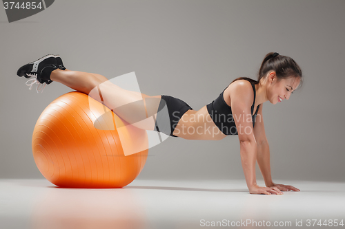 Image of The young, beautiful, sports girl doing exercises on a fitball 