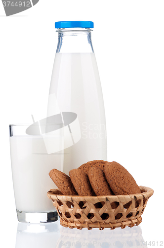 Image of Bottle of milk and glass with cookies 