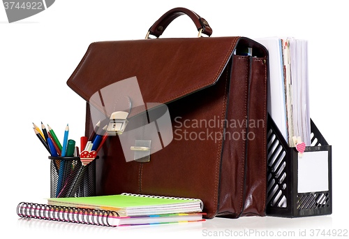 Image of Brown leather briefcase with office accessories