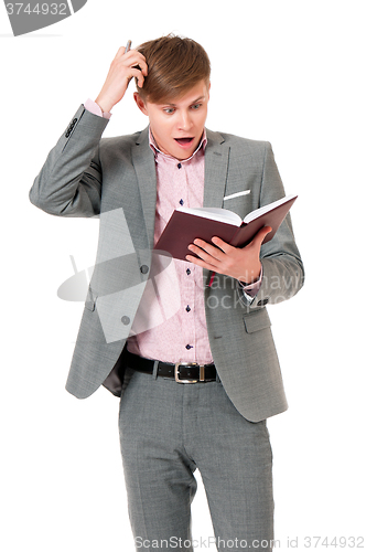 Image of Man in suit looking very shocked with notepad