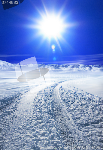 Image of Snow covered road and sun