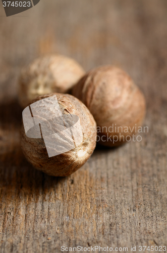 Image of Nutmeg on wooden table