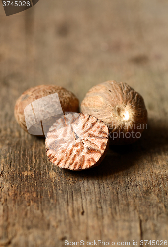 Image of Nutmeg on wooden table