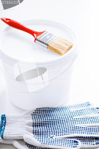 Image of paintbrush, paint pot and gloves