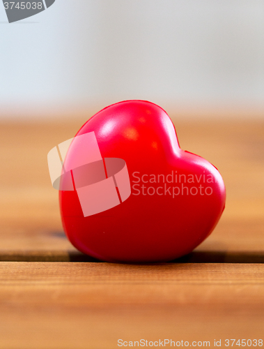 Image of close up of red heart decoration on wood