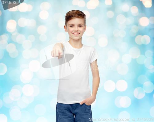 Image of happy boy in white t-shirt pointing finger to you