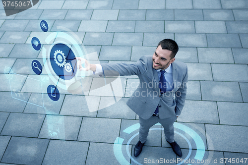 Image of young smiling businessman outdoors from top