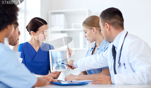 Image of group of doctors with x-ray on tablet pc at clinic