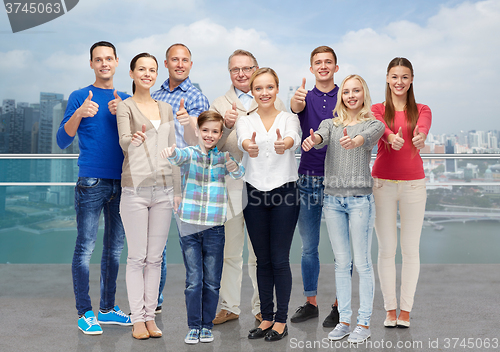 Image of group of smiling people showing thumbs up