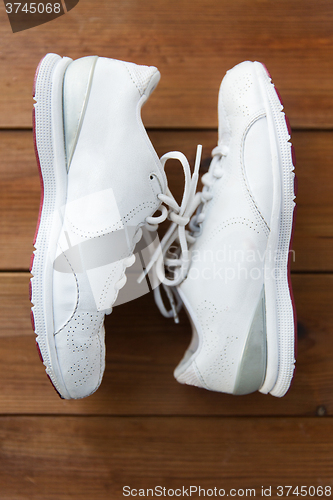 Image of close up of sneakers on wooden floor