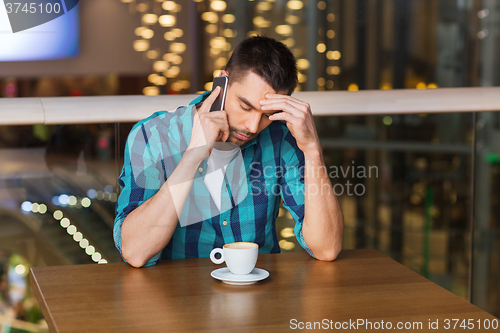 Image of man with smartphone and coffee at restaurant