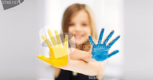 Image of girl showing painted hands