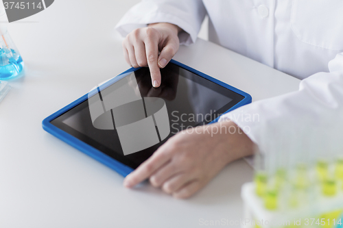 Image of close up of scientist with tablet pc in lab