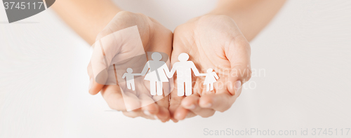 Image of woman hands with paper man family