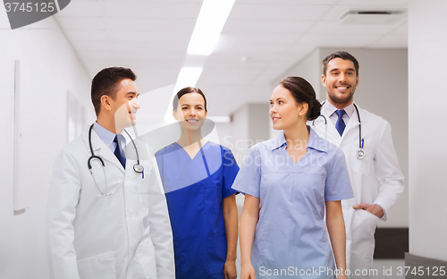 Image of happy group of medics or doctors at hospital