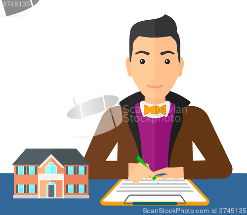 Image of Real estate agent signing contract.