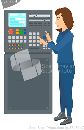 Image of Engineer standing near control panel.