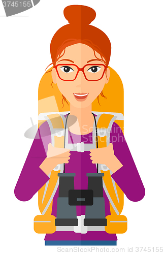 Image of Cheerful backpacker with binoculars.