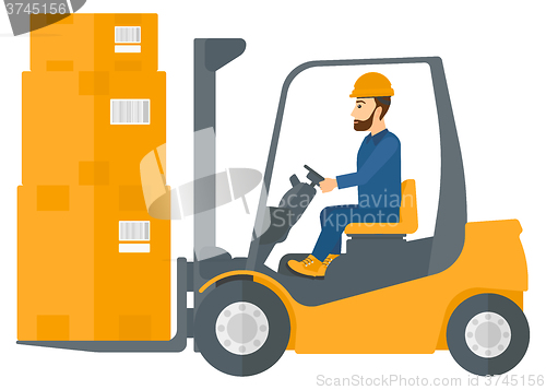 Image of Worker moving load by forklift truck.