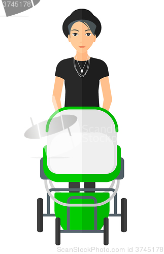 Image of Woman pushing pram.