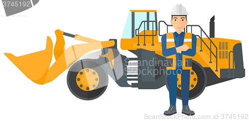 Image of Miner with mining equipment on background.